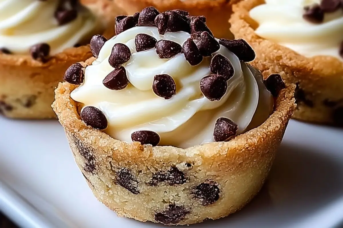 Cannoli Cookie Cups: The "No-Fry" Italian Secret (No Soggy Bottoms!) Cannoli Cookie Cups A close-up of golden cannoli cookie cups filled with creamy ricotta-mascarpone filling and topped with mini chocolate chips.