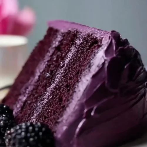 The Dreamiest Blackberry Velvet Cake (A Foolproof, No-Dye Recipe for Your Next Gathering) Dreamiest Blackberry Velvet Cake A rich, tender slice of dark purple blackberry velvet cake with thick, glossy berry frosting, served on a vintage white plate with a gold rim and garnished with fresh, plump blackberries.