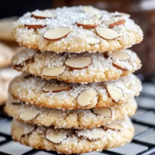 Easy 30-Minute Italian Almond Sugar Cookies Italian Almond Sugar Cookies A batch of Italian Almond Sugar Cookies dusted with powdered sugar and arranged on a rustic wooden table in warm natural light.
