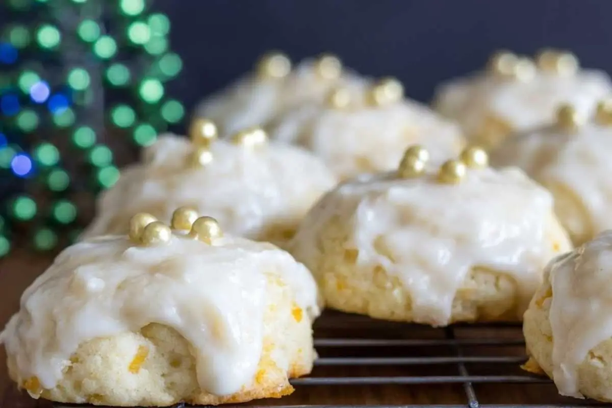 Italian Orange Ricotta Cookies: Nonna’s Make-Ahead Holiday Centerpiece Italian Orange Ricotta Cookies A plate of Italian orange ricotta cookies dusted with powdered sugar, with a soft, golden texture, arranged on a rustic wooden table.