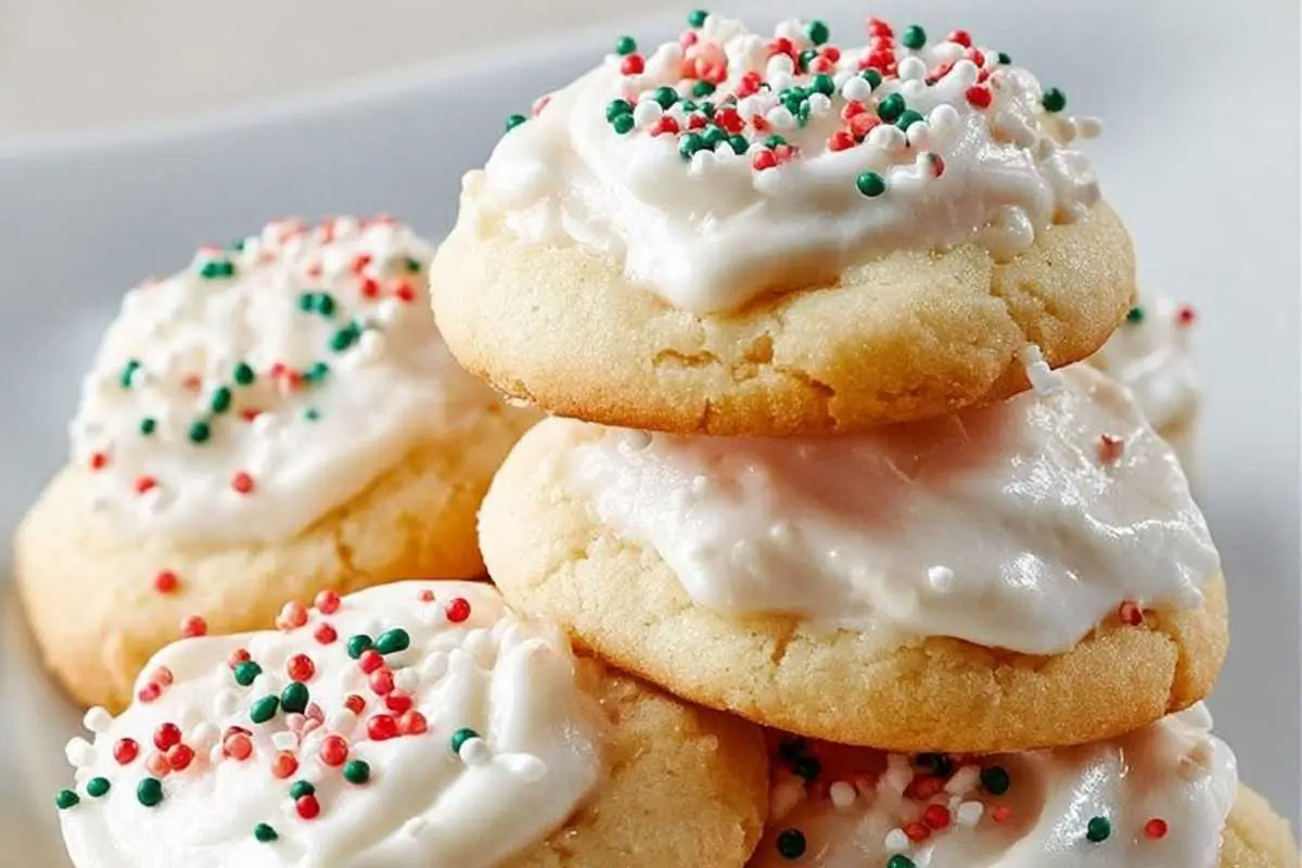 Soft & Authentic Italian Ricotta Cookies (Foolproof Family Recipe) Italian Ricotta Cookies A batch of freshly baked Italian ricotta cookies lightly dusted with powdered sugar rests on a parchment-lined baking sheet, with warm steam rising in a rustic kitchen.