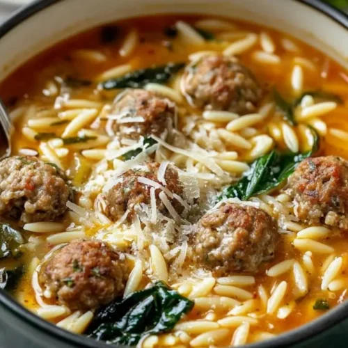 One-Pot Italian Meatball and Orzo Soup: A 30-Minute "Warm Hug" for Busy Weeknights Italian Meatball and Orzo Soup A comforting, rustic bowl of Italian meatball and orzo soup filled with tender mini meatballs, fresh spinach, and orzo pasta in a rich tomato broth, generously topped with freshly grated parmesan cheese.
