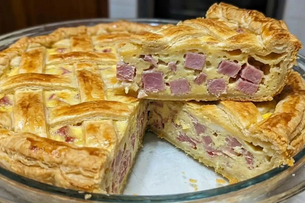Storage & Freezing The Pro-Tip for Busy Cooks A beautiful, lattice-topped savory pie in a glass baking dish with one thick slice lifted out to reveal the rich, diced meat and cheese filling, showcasing how beautifully it holds its shape when storing and freezing Italian Easter pie.