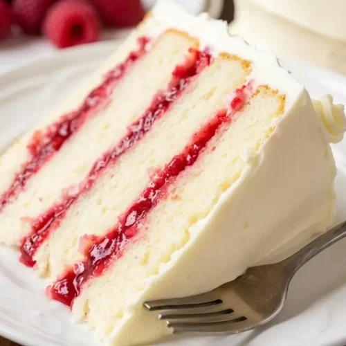 Nonna’s Foolproof Raspberry Lemon Cake: A Sunny, No-Sink Italian Bake Raspberry Lemon Cake Save this classic raspberry layer cake recipe for your next special family dinner. With a tender vanilla crumb, a bright homemade raspberry filling, and a simple rustic frosting, it’s a beautiful, stress-free dessert that connects us right back to the sweet, cherished memories of baking with our mothers and grandmothers.