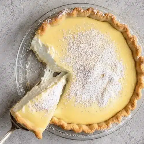 Foolproof Creamy Lemon Ricotta Pie (A Crack-Free Italian Classic) Creamy Lemon Ricotta Pie A creamy lemon ricotta pie with a flaky golden crust, topped with powdered sugar and a rich lemon layer, with a slice removed to reveal its light and fluffy filling.