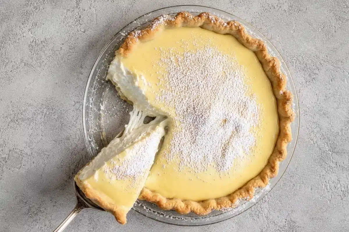 Foolproof Creamy Lemon Ricotta Pie (A Crack-Free Italian Classic) Creamy Lemon Ricotta Pie A creamy lemon ricotta pie with a flaky golden crust, topped with powdered sugar and a rich lemon layer, with a slice removed to reveal its light and fluffy filling.