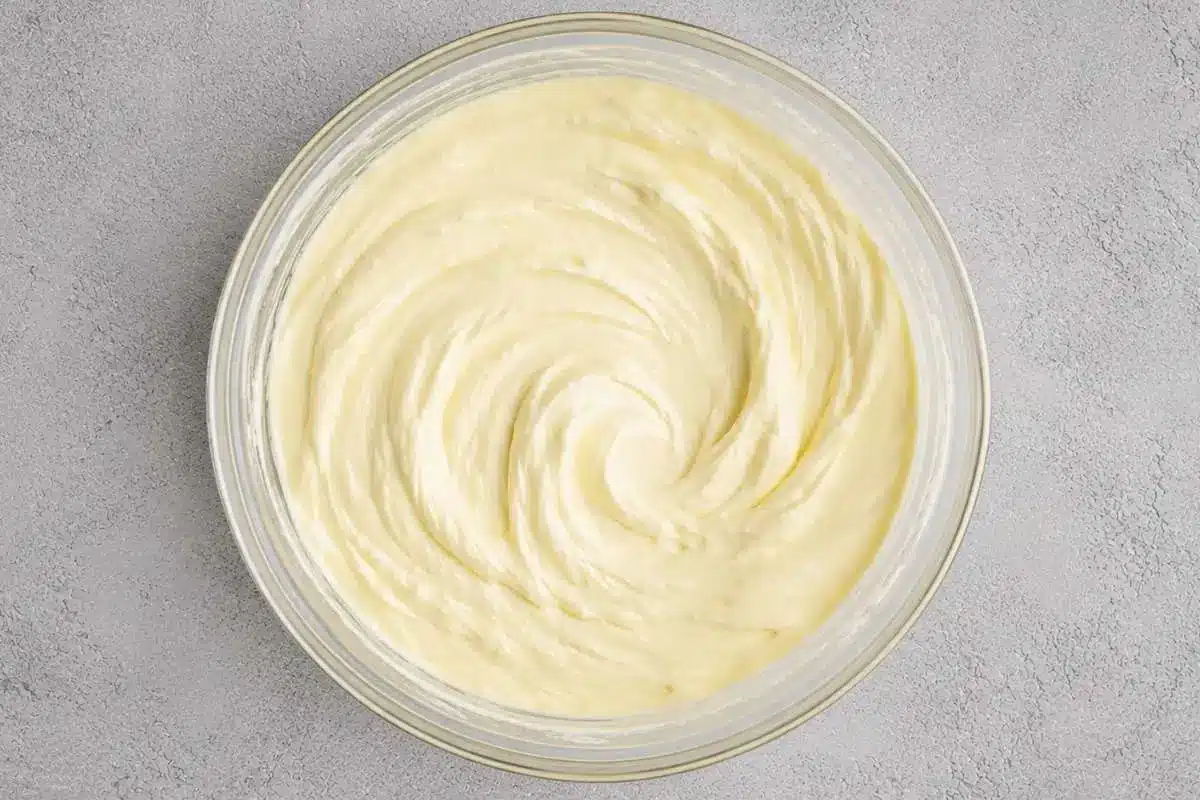 creamy-lemon-ricotta-pie-filling A bowl of smooth and fluffy Creamy Lemon Ricotta Pie filling, blended with ricotta cheese, whipped cream, and fresh lemon for a light texture.
